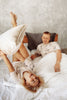 woman and man looking at each other in bed