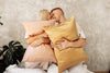 woman and man looking at each other in bed