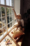 woman near the window with pillow