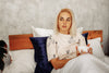 woman is drinking coffee in bed