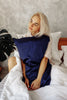 woman is hugging a silk pillowcase and smiling